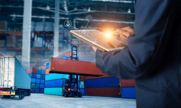 Businessman manager using laptop check orders online goods worldwide for network with Modern Trade warehouse logistics. Industry of logistics network concept.