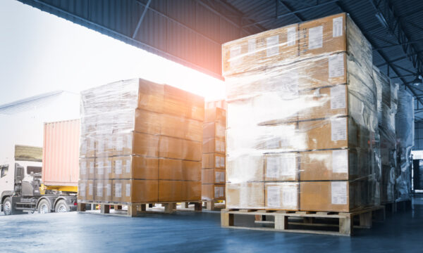 Stacked of Package Boxes Loading into Container Truck. Truck Parked Loading at Dock Warehouse. Delivery Service. Shipping Warehouse Logistics. Shipment Freight Truck Transportation.