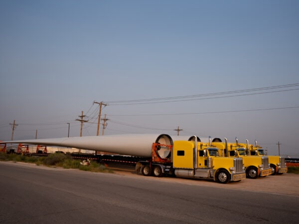 Wind Turbines Hauled By Extra Long Flatbed Semi Trailer Trucks Across The Border From Mexico, Parked Side By Side
