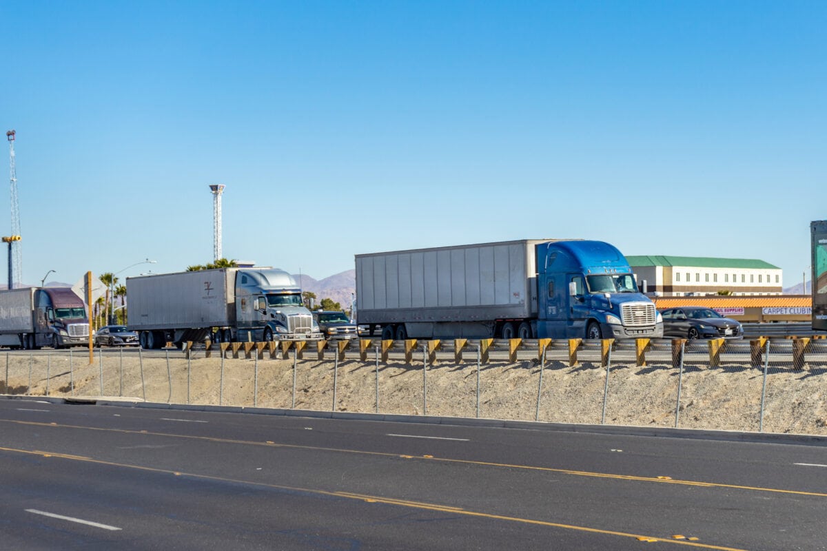Victorville, CA, USA – February 7, 2022: Semi trucks stuck in traffic on the southbound Interstate 15 in Victorville, California.